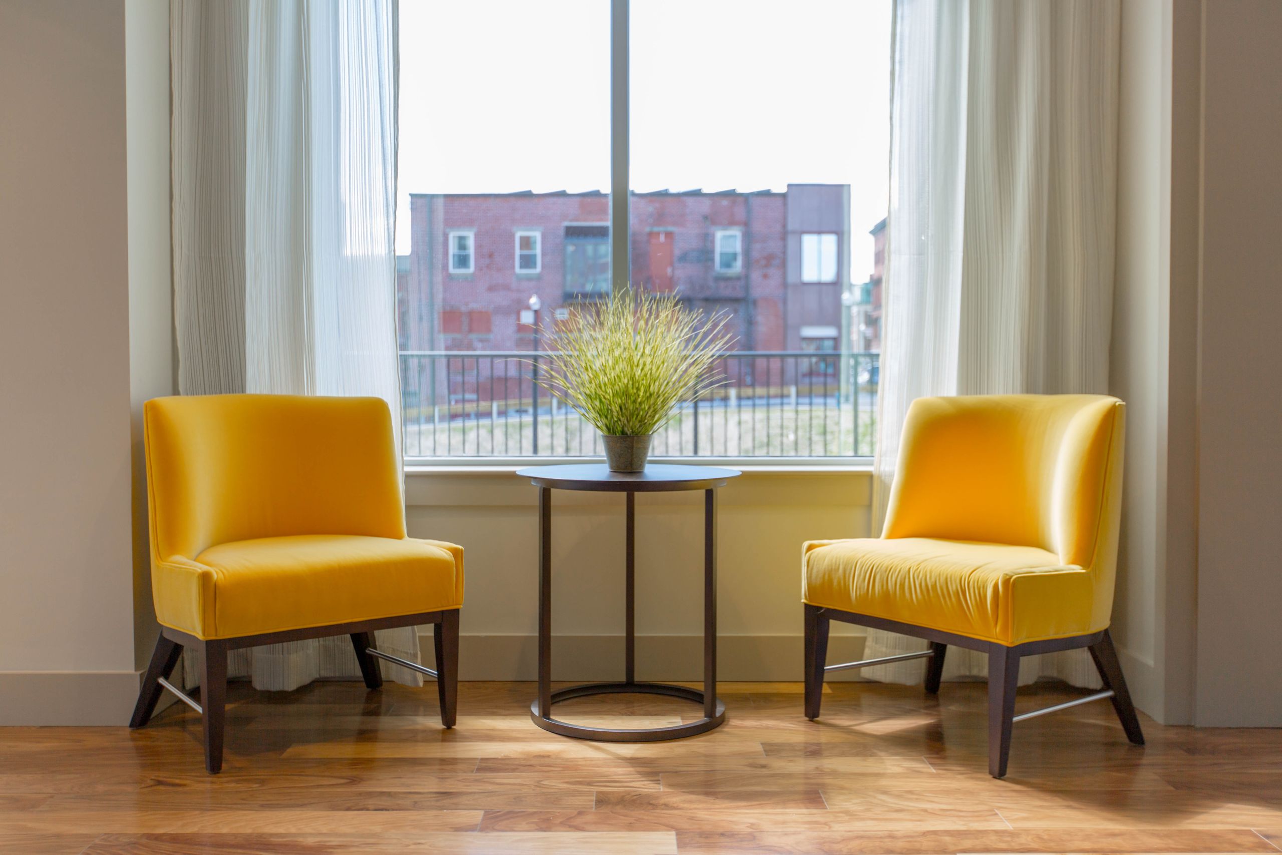 Two yellow chairs by a window